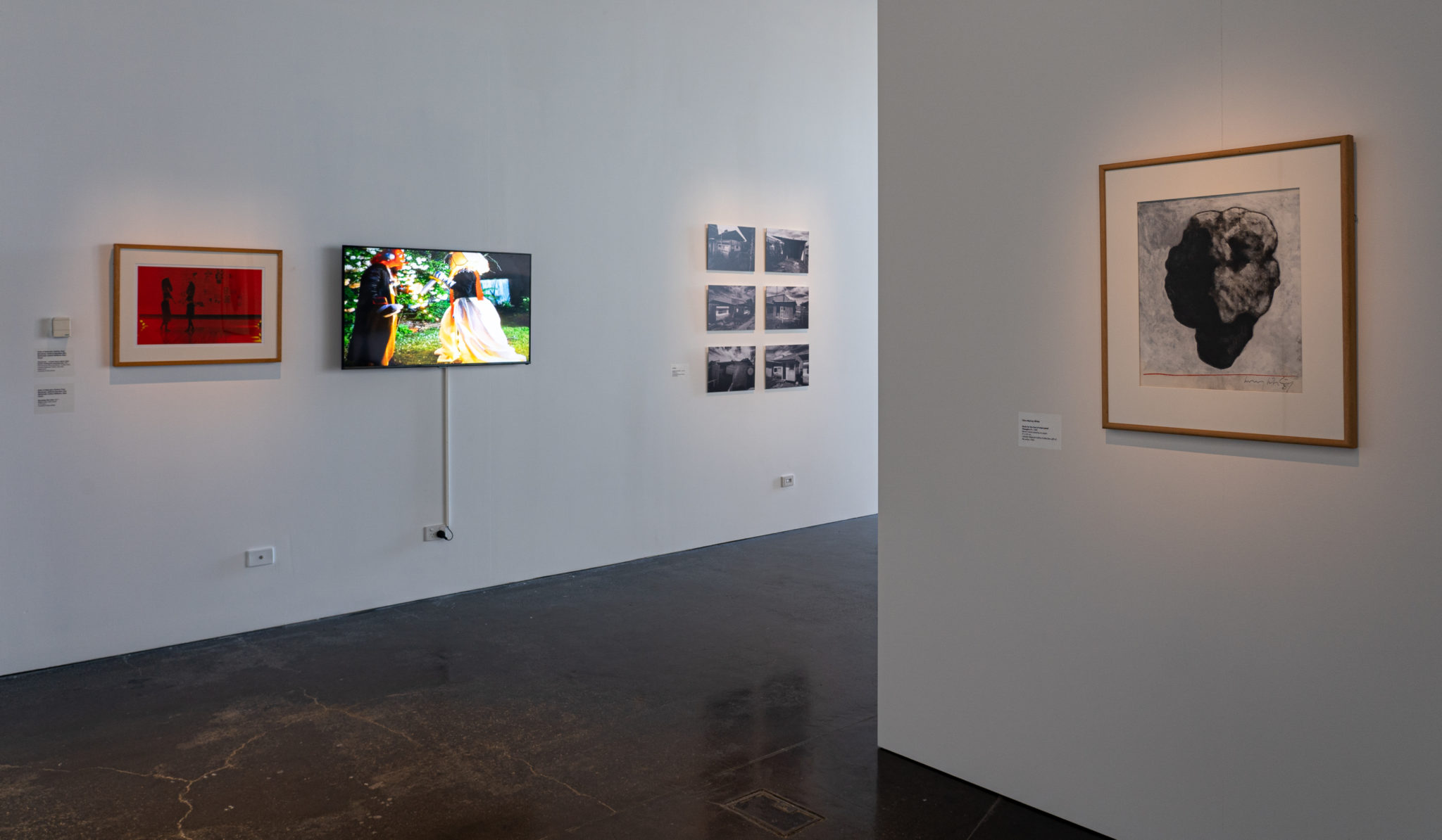 Exhibition documentation of 50 Years, 50 Artists, at Latrobe Regional Gallery, 2021. Pictured: (left, back wall) Owls of Nebraska, Checkmate – a future dance about robot horses working the assembly line, 2021, Performance documentation, 16 May 2021, Latrobe Regional Gallery, Morwell, Inkjet print, Courtesy of the artists. Owls of Nebraska, November Star Gate, 2017, Digital video with sound, 3.19 mins, Courtesy of the artists. (right, back wall) Pezaloom, Lifeboats on land (Nos. 1 – 6), 2014, C Type print, 30 x 42 cm each, Latrobe Regional Gallery Collection, purchased 2019. (front wall) Clive Murray-White, Study for the God of Interrupted Thoughts #1, 1989, Mixed media drawing on paper, 51 x 43 cm, Latrobe Regional Gallery Collection, gift of the artist, 1992.